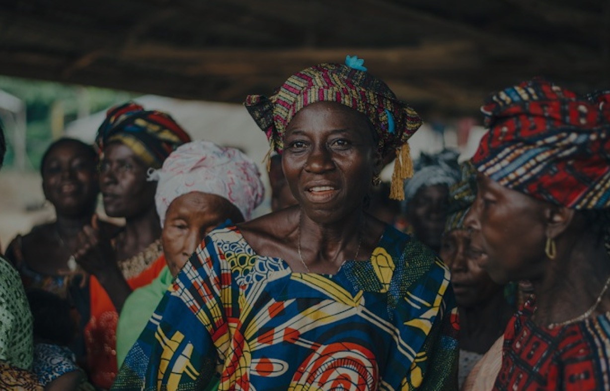 Women in colourful dress gathered at a community dialogue
